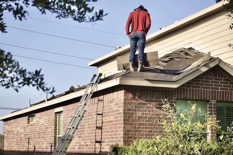 Professional roofer working on a residential roof in Candlewood Park